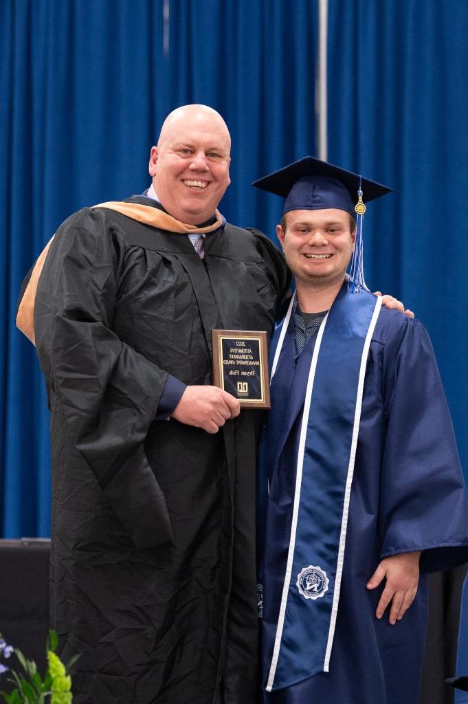 Student holding award for Honors Convocation